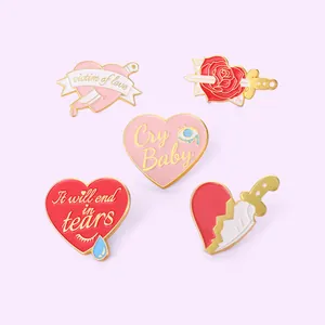 Set of 5 enamel pins featuring heart and dagger designs with emotional love quotes