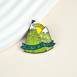 Inspirational enamel mountain pin with I've Got Mountains To Climb slogan and sun