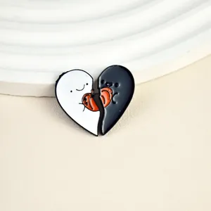 Detail of creative black and white ghost heart-shaped enamel pins with puzzle design