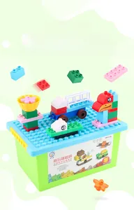 Close-up of DIY building blocks set with green storage box and colorful brick models