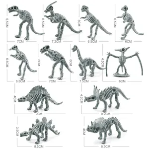 Set of 12 miniature gray dinosaur skeleton fossil models including T-Rex and Stegosaurus