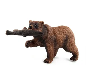 Detailed brown bear model toy holding a fish with realistic fur texture on white background