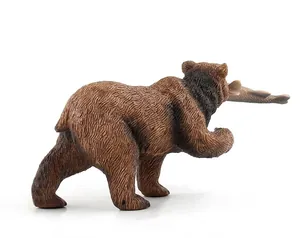 Detailed view of realistic brown bear model showing fine fur texture and a fish in its mouth