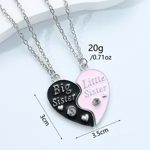 Big and Little Sister heart puzzle necklace with pink and black enamel and rhinestones