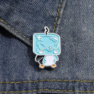 Creative cartoon penguin enamel badge on blue denim fabric as clothing accessory