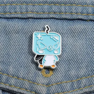 Detailed view of a square blue penguin enamel pin attached to denim fabric texture