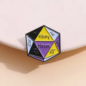 Detail of d20 geometric enamel pin with they/them pronouns and non-binary pride flag colors