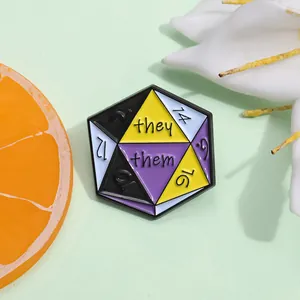 Close-up of a hexagonal Non-binary pride enamel pin with D20 dice design and they/them pronouns