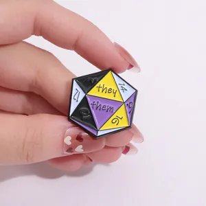 Detailed macro view of D20 dice enamel pin with they/them pronouns held by hand