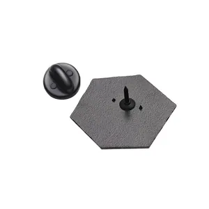 Macro shot of matte black hexagonal metal badge base with a black rubber clutch pin back
