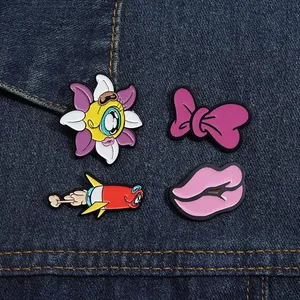 Set of 4 colorful cartoon enamel pins featuring a flower, rocket, and lips on denim fabric