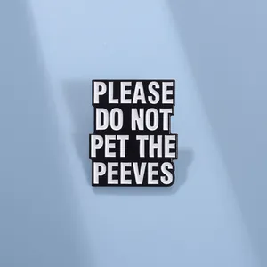 Detail of rectangular black enamel pin with white Please Do Not Pet The Peeves text