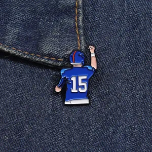 Close-up of number 15 football player enamel pin on blue denim fabric background