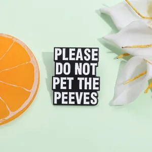 Detailed view of rectangular enamel pin with white Please Do Not Pet The Peeves text