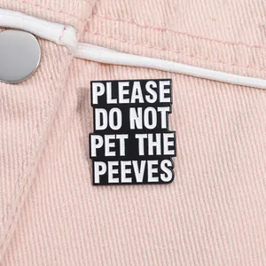 Funny enamel pin with 'PLEASE DO NOT PET THE PEEVES' slogan on pink denim jacket