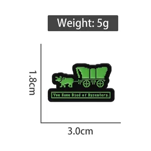 Cartoon enamel pin with pixel art carriage and 'You Have Died of Dysentery' text