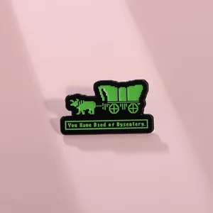 Detail of green pixel art enamel pin showing classic game text on pink background