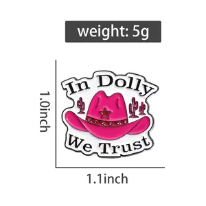 Pink enamel cowboy hat pin with In Dolly We Trust text and star details shown with dimensions