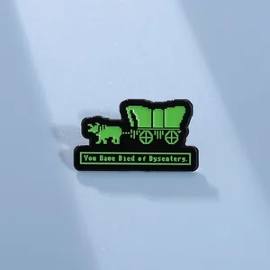 Macro shot of 8-bit pixel art enamel pin featuring a wagon and funny gaming slogan
