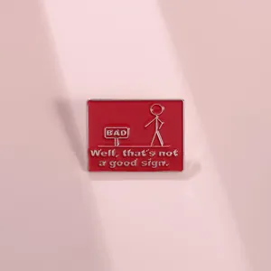 Detailed view of red enamel pin with minimalist stick figure and funny quote