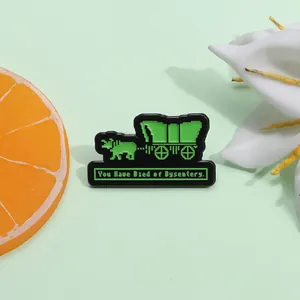 Retro pixel art enamel pin featuring cow wagon design and humorous gaming text
