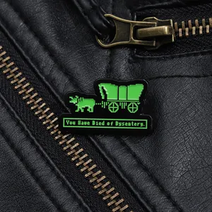 Close-up of pixel art enamel pin with You Have Died of Dysentery text on leather jacket
