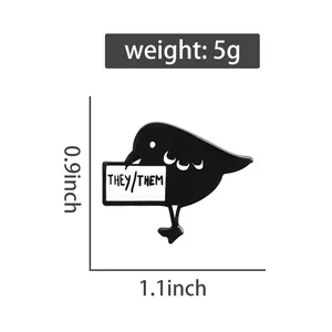 Detail view of bird enamel pin with They/Them pronouns, weight 5g and size 0.9x1.1 inches