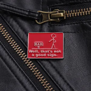 Macro view of funny stickman enamel pin on black leather jacket with double entendre text