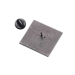 Detail view showing the textured metal back and black rubber pin clutch of the badge