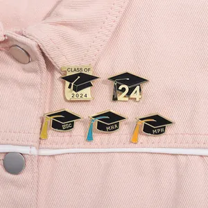 Enamel graduation pins on pink denim with Class of 2024 text and doctor hat detail