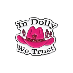 Pink cowboy hat enamel pin featuring In Dolly We Trust text and cactus details