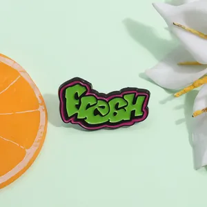 Grüne Emaille-Anstecknadel im Graffiti-Stil mit 'Fresh' Schriftzug im 80er-Jahre-Look