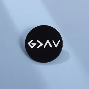 Macro shot of circular enamel lapel pin with 'God is greater' geometric symbols on blue