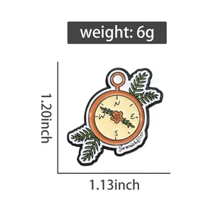 Detail view of enamel compass brooch with floral accents and precise size measurements