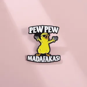 Detail of cartoon duck enamel pin with Pew Pew Madafakas slogan on pink background