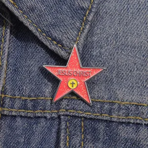 Detail of red glitter pentagram Jesus Christ enamel pin on a denim jacket collar