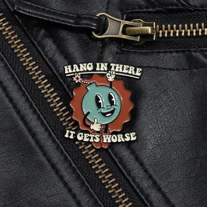 Cartoon enamel pin with bomb design and dark humor text on a black leather jacket