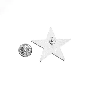 Silver star metal brooch detail showing the back pin and butterfly clutch backing