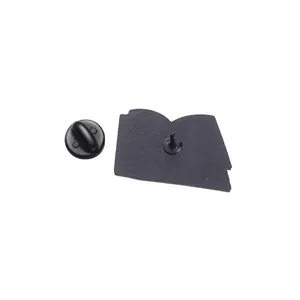 Detail view of the black metal pin back with a secure needle and rubber clutch closure
