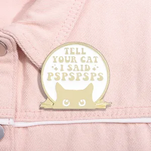 Close-up of Tell Your Cat I Said Pspsps enamel pin on a pink denim jacket collar