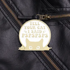 Detail of round enamel cat badge with PSPSPSPS text on a black leather jacket