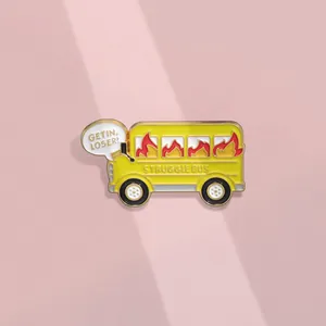 Detail of yellow school bus enamel pin with Struggle Bus and Get In Loser text designs