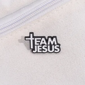 Detailed close-up of Team Jesus enamel pin with cross on off-white canvas bag fabric