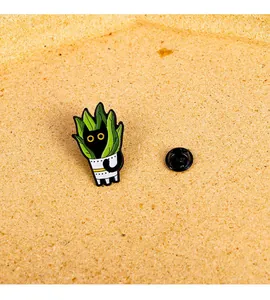 Detailed close-up of a black cat enamel pin hidden in a green snake plant pot