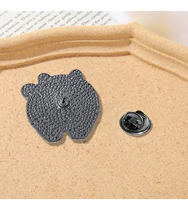 Close-up of animal brooch back with metal butterfly clutch and textured gunmetal finish
