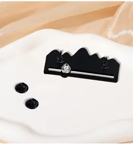Macro shot showing the sliding mechanism and dual pin backs of the mountain brooch