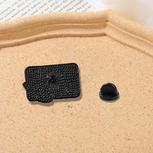 Close-up of the black textured metal badge back and durable rubber pin clutch backing