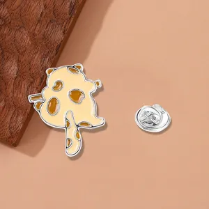 Cute cartoon animal enamel pin with silver butterfly clutch and warm wood background