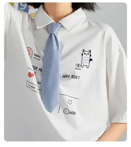 Detail of cartoon cat print on white cotton polo t-shirt with blue striped tie
