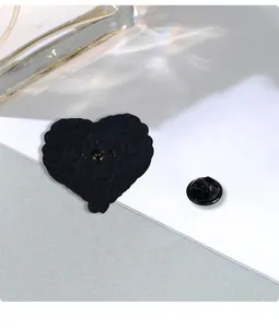 Macro shot showing the textured back of a heart pin with its butterfly clutch attachment